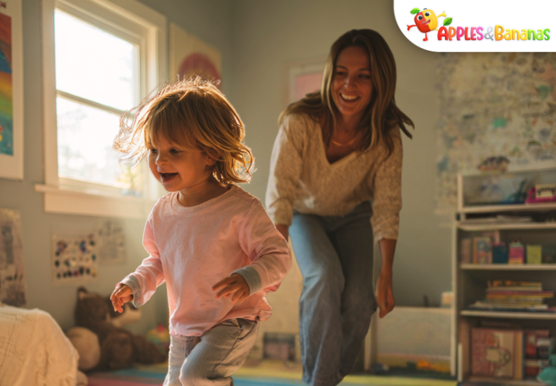 A soft digital illustration of a lively toddler playing joyfully with a parent in a bright, cozy living room. The scene includes toys, a soft rug, and an open area designed for an app mascot.